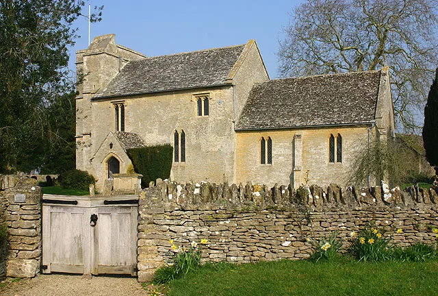 St George's parish church Kencot, Oxfordshire, seen from the southeast. The church is 12th century; the gates were installed in 1937 to commemorate the coronation of King George VI.