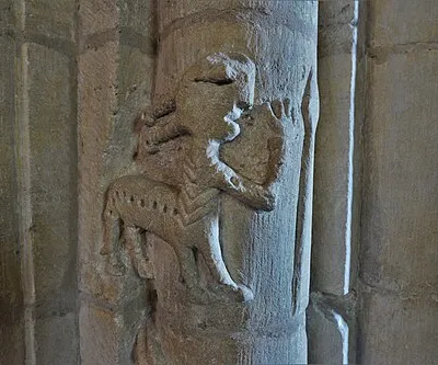 Beckford, St. John the Baptist Church: Carving of centaur reaching for a spear on the tower arch