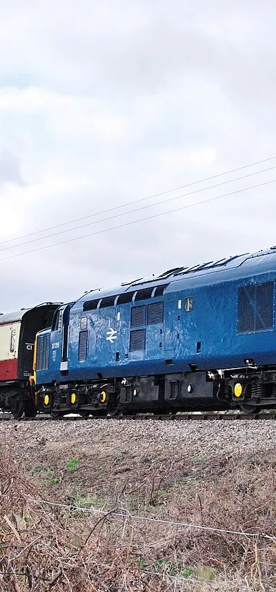 Preserved English Electric Class 37/0 1,750 hp Co-Co No.37 215 (ex-D6915) in BR blue livery, approaching Toddington with a service from Winchcome, G-WR, 3/10.