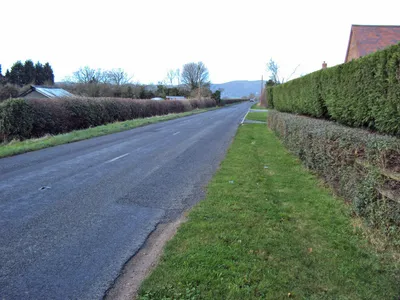 A4104 at Lower Hook Looking north-west along the straight main road heading for Welland. Pinnacle Hill in the distance.