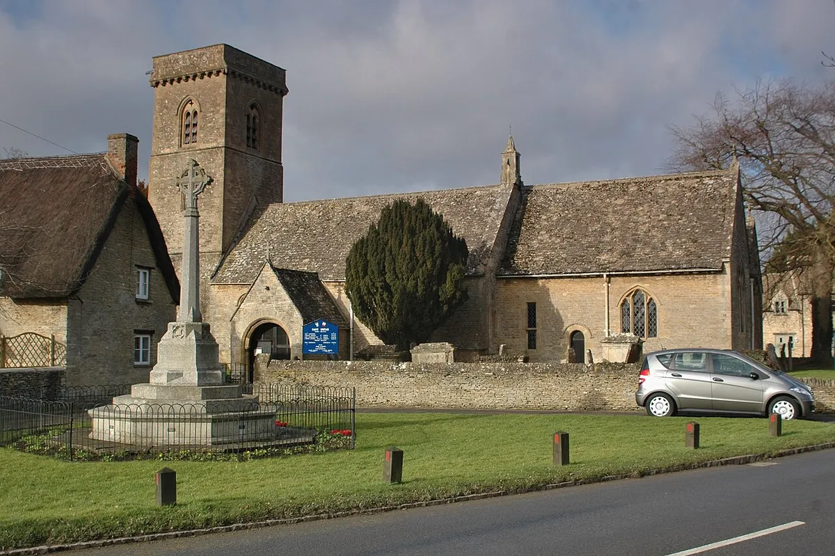 Parish church of St Britius and parish war memorial, Brize Norton, Oxfordshire, seen from south-southeast