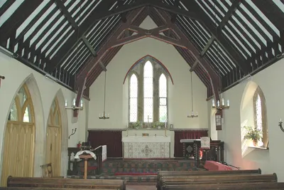 Church of England parish church of St John the Evangelist, Hempton, Oxfordshire: interior of nave, looking east to the chancel. The two arches of the north arcade are on the left.