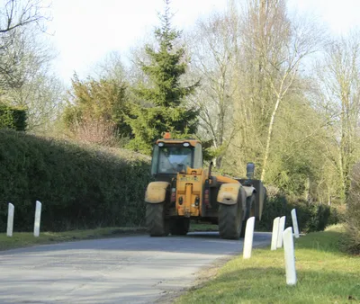 Farm machinery passing Boldehyde Manor That bucket was big enough to give me and my car a lift.