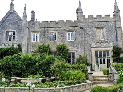 The castellated manor house at Bradwell Grove, with the lily pond in front of it
