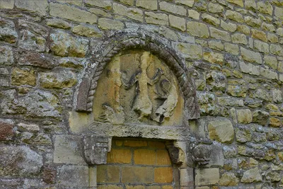 Beckford, St. John the Baptist Church: Badly worn tympanum above the blocked north doorway