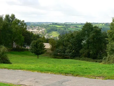 A view towards Nailsworth from the north The road to Theescombe is in the foreground. In the distance are the north-western outskirts of Nailsworth.