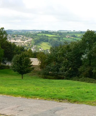 A view towards Nailsworth from the north The road to Theescombe is in the foreground. In the distance are the north-western outskirts of Nailsworth.
