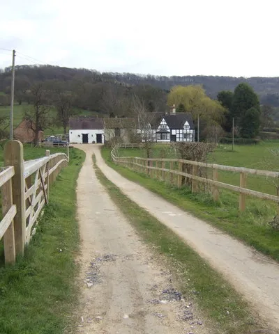 Black and white house at Great Witcombe In a fine position backed by the Cotswold escarpment.
