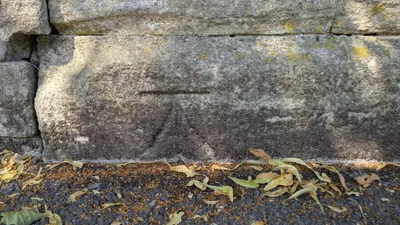 Benchmark on corner wall pier of cemetery on north side of road