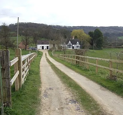 Black and white house at Great Witcombe In a fine position backed by the Cotswold escarpment.