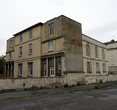 Portland Street, Cheltenham Spa. Villa built 1816 with later additions and alterations including mid-C20 upper storeys to end ranges;