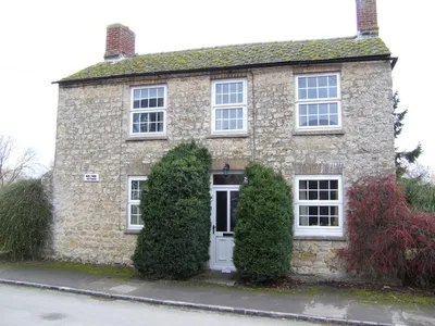 Box Tree Cottage, Great Coxwell, Oxfordshire (formerly Berkshire), seen from the east. Two box trees flank the front door.