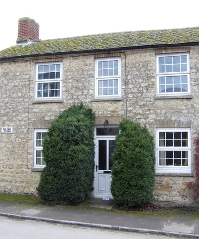 Box Tree Cottage, Great Coxwell, Oxfordshire (formerly Berkshire), seen from the east. Two box trees flank the front door.