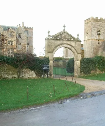 Chastleton House and St. Mary the Virgin parish church with the main entrance between. The house was built circa 1602-18 and the church tower was built in 1689.