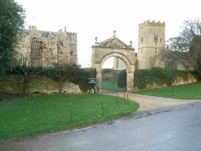 Chastleton House and St. Mary the Virgin parish church with the main entrance between. The house was built circa 1602-18 and the church tower was built in 1689.