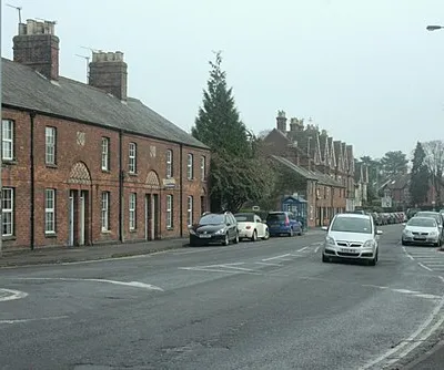 A361 London Road, Devizes The red brick used in the houses on the north side of this road is typical of Devizes and the Vale of Pewsey to the east. Built mostly in the 18th and 19th centuries it suggests the presence of suitable clay.
The date on the nearest rank is 1884.