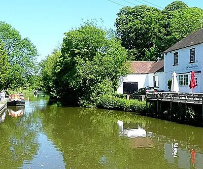 Canal east of Kintbury This is the view leaving Kintbury Lock heading east, with the Dundas Arms on the right and the mooring for the horse drawn trip boat Kennet Valley to the left.