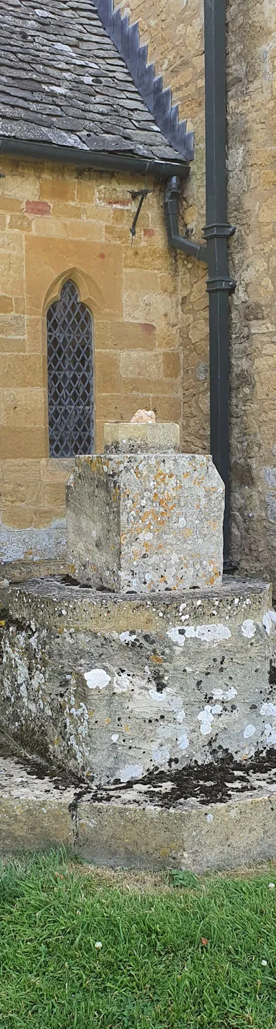 Broken war memorial in the grounds of St Nicholas church, Saintbury