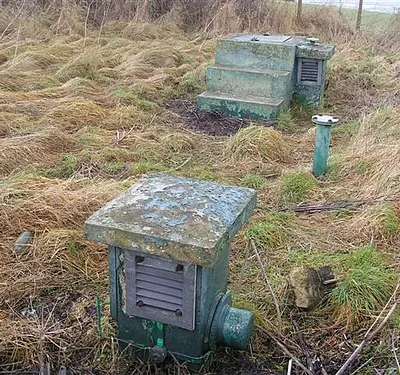 Ventilator (foreground) and entrance (beyond) of a disused bunker beside the B4000 road on Ashbury Hill, Oxfordshire (formerly Berkshire)