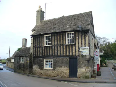 Bridge Street Old stone cottage with half-timbered upper level in central Fairford. To the left is Bridge Street.