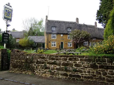 The North Arms, Mills Lane, Wroxton, Oxfordshire, seen from the south. When this photo was taken the pub was controlled by Greene King Brewery.