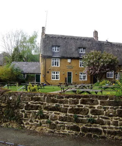 The North Arms, Mills Lane, Wroxton, Oxfordshire, seen from the south. When this photo was taken the pub was controlled by Greene King Brewery.