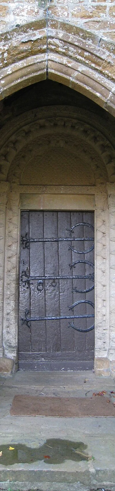 North door of church at Barford St. Michael, Oxfordshire. Gothic porch with Norman doorway.