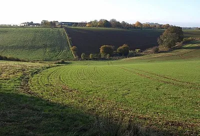 Combe, Sugarswell The valley of one of the headwaters of the Sor Brook, a tributary of the Cherwell, seen from the Macmillan Way. Beyond is Sugarswell Business Park, in SP3543, formerly a farm.