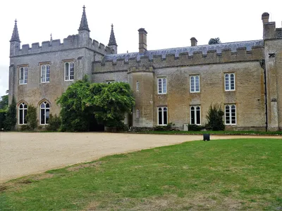 The castellated manor house at Bradwell Grove seen across the gravel forecourt