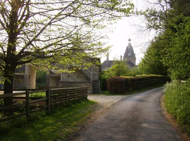 Approaching Rendcomb You feel as though you are approaching a French chateau here, on this lane in rural Gloucestershire. The building ahead is actually the stable block of Rendcomb College.