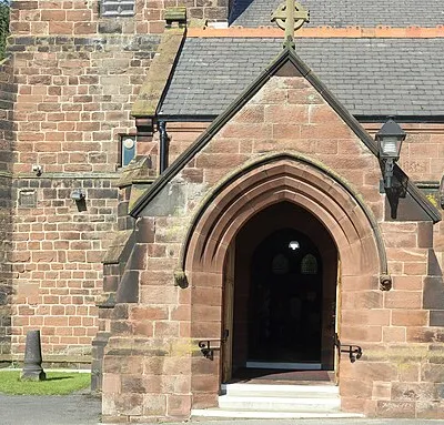Porch at the south west corner of the church, also showing the location of the Grade II listed sundial.