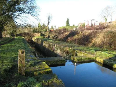 Beale's Lock, Brimscombe Tidied up and with the masonry in a reasonable condition but with the top gates currently replaced by a dam.  The GWR Gloucester - Swindon line is on the bank to the right and the site of Brimscombe Station as just beyond the red barrier.