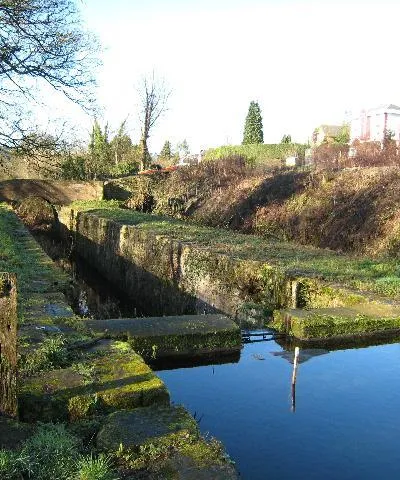 Beale's Lock, Brimscombe Tidied up and with the masonry in a reasonable condition but with the top gates currently replaced by a dam.  The GWR Gloucester - Swindon line is on the bank to the right and the site of Brimscombe Station as just beyond the red barrier.