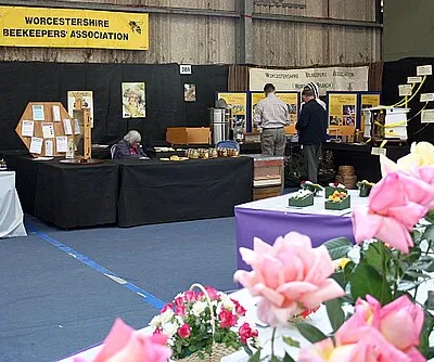 Bees' stand, Spring Gardening Show, Malvern 2009 One of the many indoor stands for associated societies.
Beekeeping has been in the news recently due to unexplained Colony Collapse Disorder threatening the polination of worldwide food crops.
Hundreds of concerned visitors enquired into how to take up bee keeping.
A cut away of a hive was very popular as was the display of live bees - safely enclosed behind glass. 
Displays of the equipment used by beekeepers was on display along with flowers loved by bees. 
Honey and beeswax was on sale. 

At least one stallholder almost lost his voice by after eight hours.