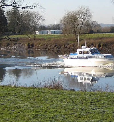 Cruising upriver Friendly waves from the occupants as they chug up the River Severn on a frosty January day.