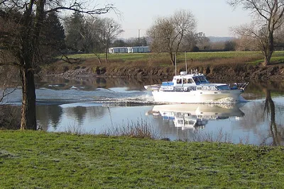Cruising upriver Friendly waves from the occupants as they chug up the River Severn on a frosty January day.