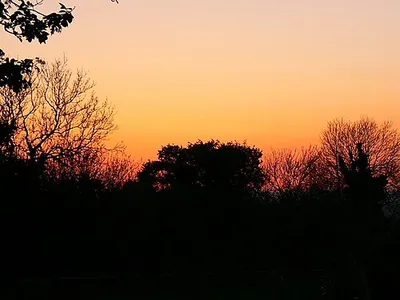 Blunsdon Hill fort at sunset, Blunsdon, Swindon Because of a large fire in a farmyard north of here, there was quite a lot of smoke in the air, which may have contributed to the filtering of the light to produce this reddish effect in the sky