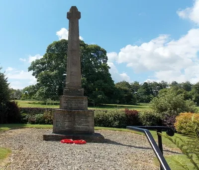 War Memorial Cross, Miserden
Designed by Edwin Lutyens, the Memorial was installed c1920 to the south of the village church.
The dedication in view is TO THE MEMORY OF OUR GLORIOUS DEAD 1914-1919. The year 1919 is not a mistake. Although the end of the Great War is often stated to date from the armistice of November 11th, 1918, officially a formal state of war persisted until the signing of the Treaty of Versailles with Germany on June 28th 1919.