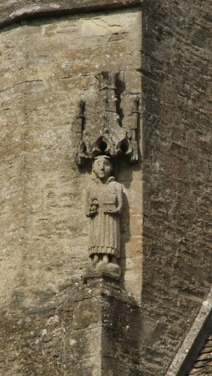 Canopied 14th- or 15th-century statue of St Stephen on the southeast corner of the west tower of St Stephen's parish church, Clanfield, Oxfordshire