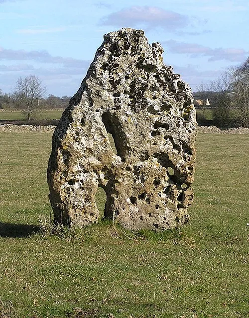 Long Stone The Long Stone is believed to be the closing slab from a burial chamber or portal dolmen. A smaller stone can be seen in the field wall approximately 30m away. This may also have come from the same chambered tomb.
The stone is located on the Minchinhampton to Avening road about half a mile from Hollybush Farm. It is set just off the road with easy access.