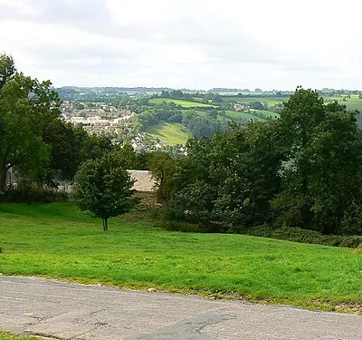 A view towards Nailsworth from the north The road to Theescombe is in the foreground. In the distance are the north-western outskirts of Nailsworth.