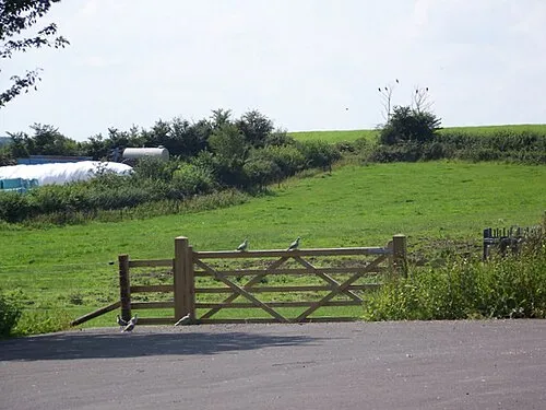 Footpath, Bushton The footpath crosses the village hall car park and then grazing fields on its way to Woodhill Park.