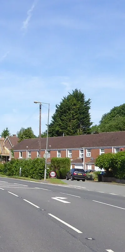 A terrace of modern houses and an older, thatched house, Froxfield