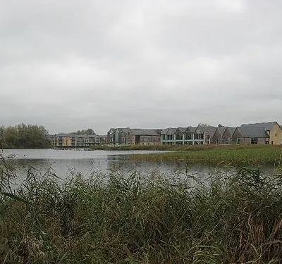 Cotswold Water Park Looking across the flooded former gravel pits towards some of the buildings erected as part of the water park development.