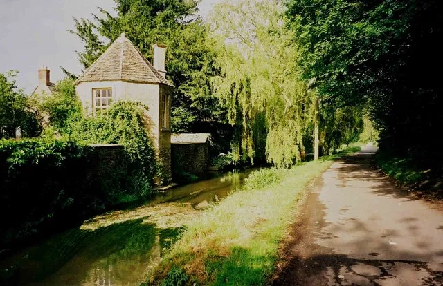 A lane called Bow Wow The extraordinarily named Bow Wow is one of the most attractive parts of the large village of South Cerney, which is situated in the Cotswolds Water Park. The building on the left is a gazebo, in the grounds of The Old Rectory. Bow Wow, further on, leads into the countryside, crosses the dismantled Swindon - Cirencester railway line and shortly afterwards meets the currently disused Thames & Severn Canal. It then becomes a private road leading to a farm and cottages.