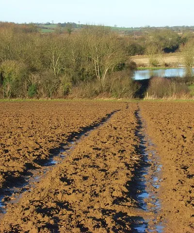 Bridleway at Prescote, Oxfordshire. A waterlogged bridleway descending to the road near Broadmoor Bridge. Below are the floodwaters of Highfurlong Brook.