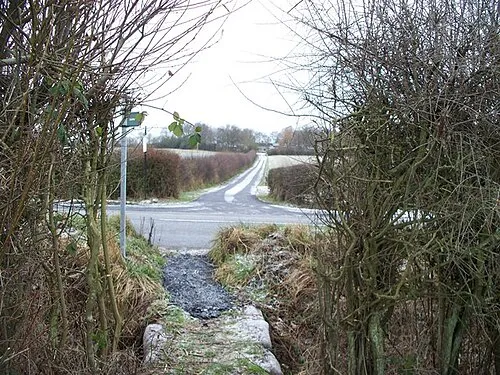 Across the road The diverted footpath from Kingham meets the B4450 opposite the entrance to Bluewood Park.