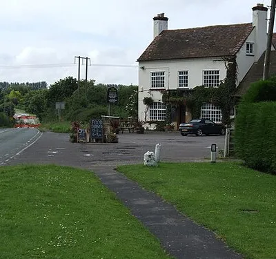 Hole in the road near the New Inn Looking past the New Inn to the collapsed section of road caused by heavy rain on Friday 20th July 2007.