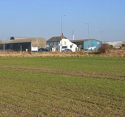Bush House Farm Located at a busy crossroads on the A346. Traffic can be seen emerging from the Ridge Way, the minor road from the east.