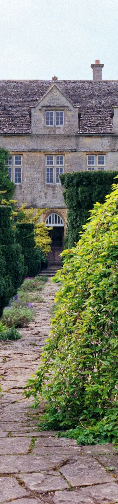 1992 Spring photograph along a path from the gardens at the east towards Barnsley House, at the time Rosemary Verey was in residence and directly caring for the garden.Processing: SLR camera Kodak Gold ASA 200-2 film negative scanned with an Epson Perfection V800 using SilverFast 8 scan program, and optimized, cropped and spun with DxO OpticsPro 10 Elite and Adobe Photoshop CS2.